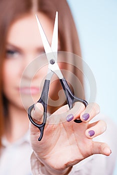 Young professional hairdresser with scissors.