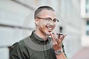 Young, professional and happy businessman using a phone outdoors. Positive male smiling while speaking on a call