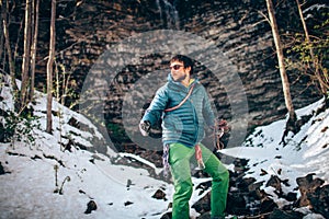 Young professional male climber is preparing to climb.