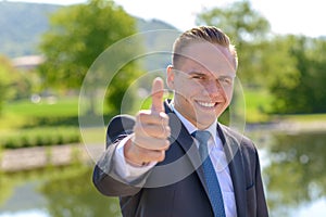 Young professional man giving a thumbs up gesture