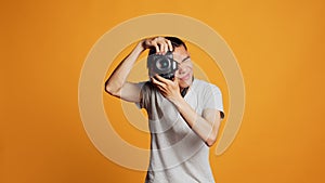 Young professional photographer using dslr camera