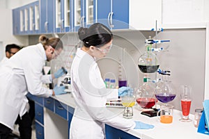 Young professional scientists making experiment in research laboratory