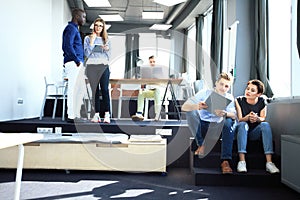 Young professional team. Group of young modern people in smart casual wear standing in the creative office