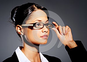Young professional touching her glasses