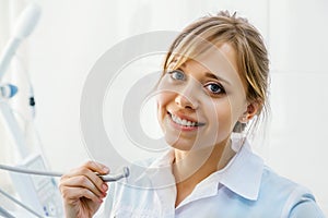 Young Professional Woman Dentist with Dental Drill