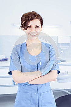 Young professional woman dentist in the dental office