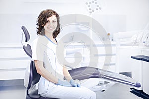 Young professional woman dentist in the dental office