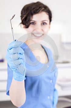 Young professional woman dentist in the dental office