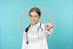 Young professional woman doctor, medical worker showing okay, ok zero gesture and smiling satisfied, recommending