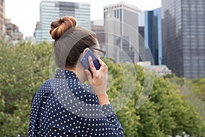 Young professional woman on the phone in the city