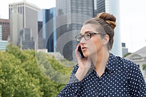 Young professional woman on the phone in the city