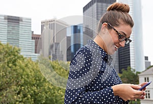 Young professional woman texting in the city