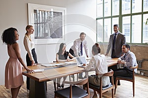 Young professionals around a table at a business meeting