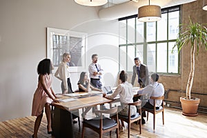 Young professionals around a table at a business meeting