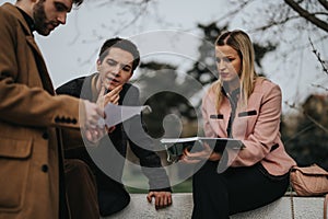 Young professionals engaged in an outdoor strategic marketing discussion for business growth