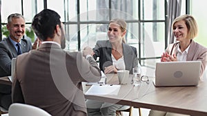 Young professionals having a discussion at a meeting in a modern office