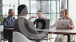 Young professionals having a discussion at a meeting in a modern office