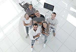 Young professionals standing near the desktop