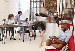 Young professionals working in a busy open plan office