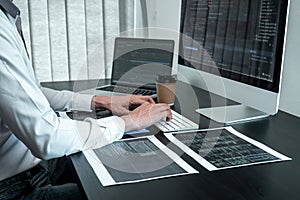 Young Programmer working in software javascript computer in IT office, Writing codes and data code website and coding database