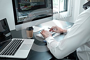 Young Programmer working in software javascript computer in IT office, Writing codes and data code website and coding database
