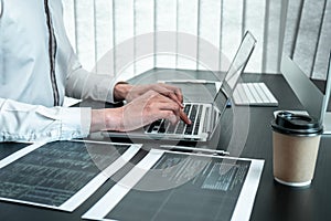 Young Programmer working in software javascript computer in IT office, Writing codes and data code website and coding database