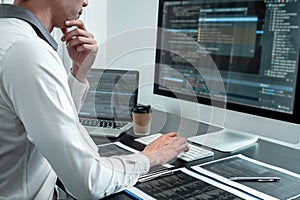 Young Programmer working in software javascript computer in IT office, Writing codes and data code website and coding database