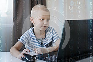 Young programmer writing code on a computer at home. Programming lessons for kids.