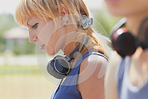 Young punk girl with wireless headphones