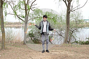 Young punk man juggling cariocas in a park