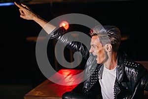 Young punker doing a rock hand gesture