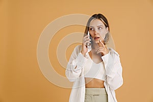 Young puzzlement woman talking on mobile phone