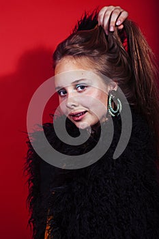 young pyoung pretty emitonal posing teenage girl on bright red background, happy smiling lifestyle people concept