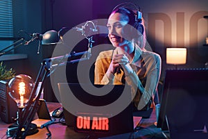 Young radio host broadcasting in the studio