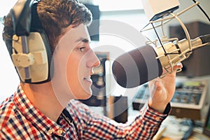 Young radio host broadcasting in studio