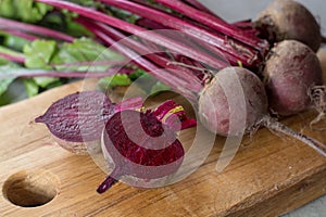 Young raw red beets roots with leaves