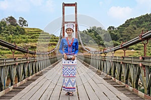 young Rawang woman in traditional Rawang dress at Kaungmulone Bridge across Mali Kha River in Putao, Kachin state. Myanmar