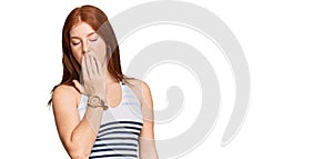 Young read head woman wearing casual clothes bored yawning tired covering mouth with hand