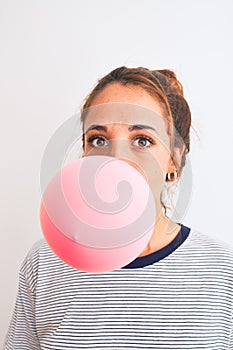 Young readhead modern woman chewing gum and doing air bubble