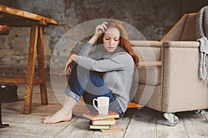 Young readhead student woman learning and reading books