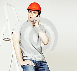 young real hard worker man isolated on white background on ladde