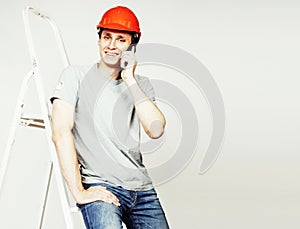 young real hard worker man isolated on white background on ladde