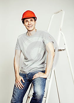 Young real hard worker man isolated on white background on ladder smiling posing, business concept