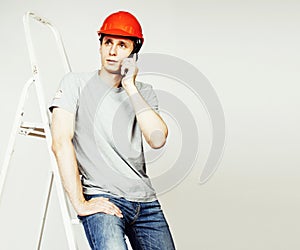 Young real hard worker man isolated on white background on ladder smiling posing, business concept