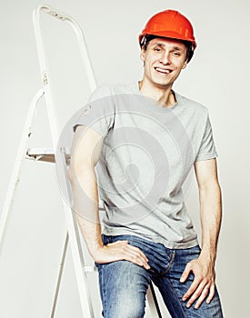 Young real hard worker man isolated on white background ladder smiling posing, business concept