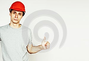 Young real hard worker man on white background on ladde