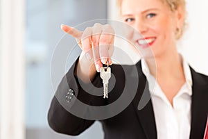 Young realtor is with keys in an apartment