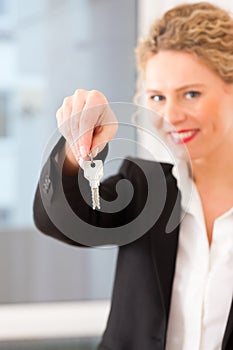 Young realtor is with keys in an apartment