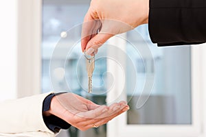 Young realtor is with keys in an apartment