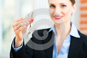 Young realtor is with keys in an apartment